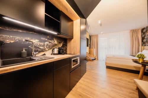 a kitchen with a sink and a bed in a room at Rioca Stuttgart Posto 4 in Stuttgart