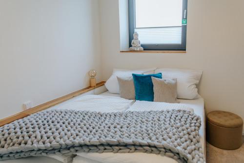 a bedroom with a bed with a blanket on it at Village Turmzimmer in Kehl am Rhein