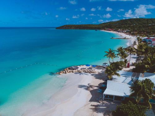 an aerial view of a beach with palm trees and the ocean at Siboney Beach Club in Saint Johnʼs