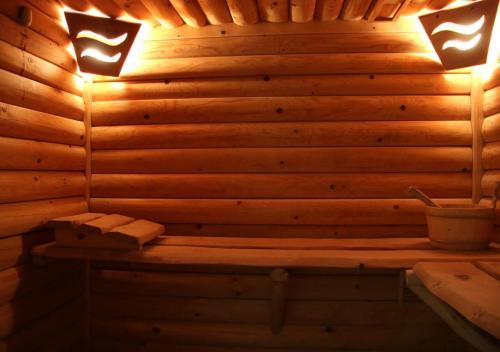 a sauna with two lights on a wooden wall at DW Pod Jaworami - relaks w SPA - jacuzzi, sauna na wyłączność in Białka Tatrzanska