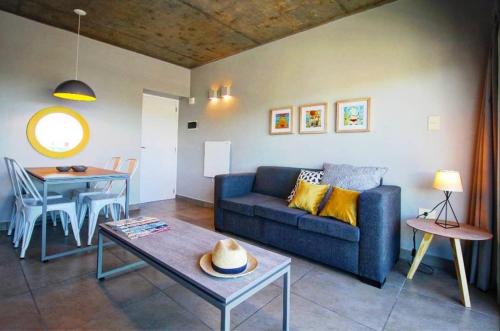 a living room with a blue couch and a table at Naranjo 9D in San Salvador de Jujuy