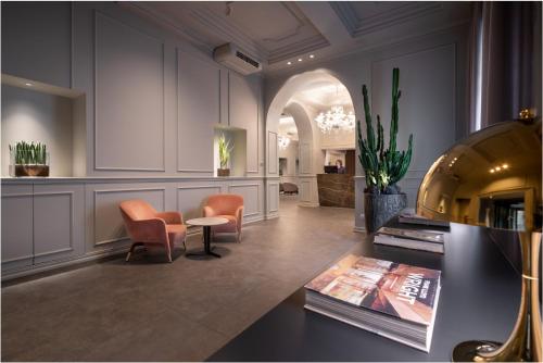 een lobby met stoelen en een tafel in een kamer bij WorldHotel Casati 18 in Milaan