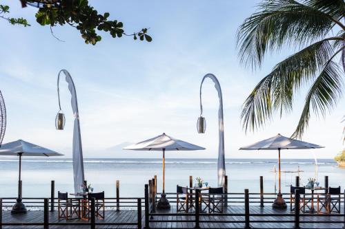 a wedding reception on the beach with tables and umbrellas at Meliá Bali in Nusa Dua