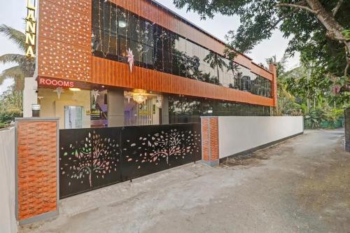 a building with a fence in front of it at Melanna Cherai Beach Resorts in Cherai Beach