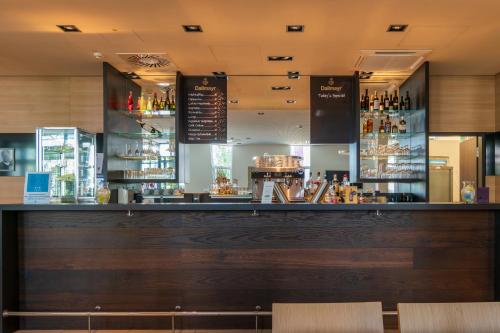 a bar in a restaurant with a counter top at Star G Hotel Premium München Domagkstraße in Munich