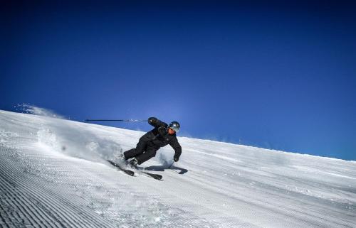 a person is skiing down a snow covered slope at Park Hotel Panorama in Bansko