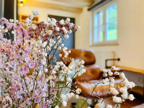 a bunch of flowers in a room with a couch at RotmeerHaus in Feldberg