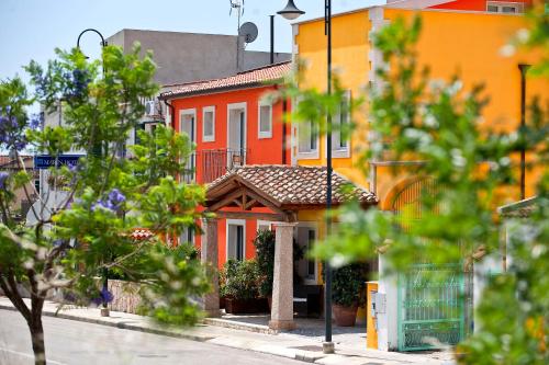 a row of orange houses on a city street at Marin Hotel in Pula