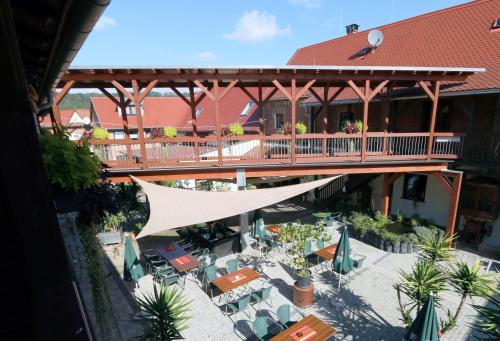 an overhead view of a building with a bridge and tables at Hotel Sonnekalb in Naumburg