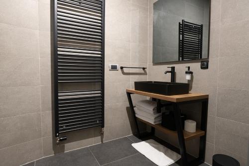 a bathroom with a sink and a mirror at SAVOY residence in Osijek