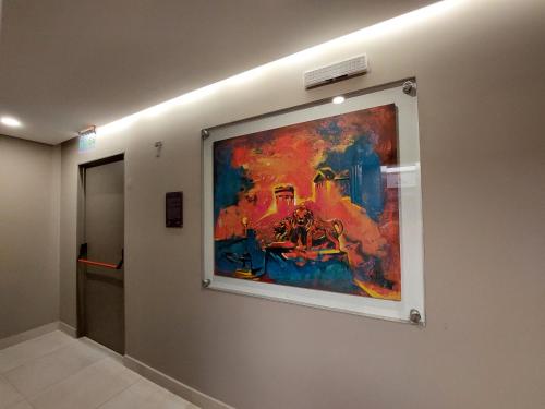 a painting hanging on a wall in a hallway at Departamento Torre Murguía in San Salvador de Jujuy