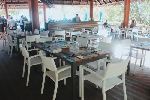 une salle à manger avec une table et des chaises blanches dans l'établissement Bluewater Sumilon Island Resort, à Sumilon Island