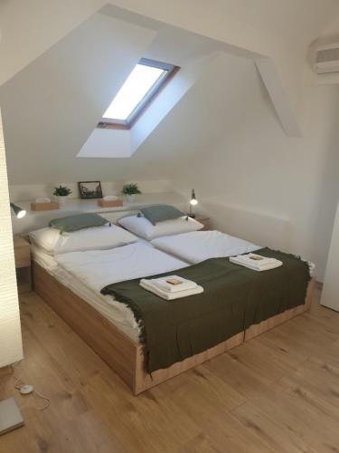 a bedroom with a large bed in a attic at Pribina Penzión in Nitra