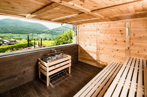 a sauna with a bench and a window at Pension Hasslhof in Caldaro