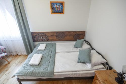 a bed with two pillows on it in a room at Moje Tatry Gluten Free in Biały Dunajec