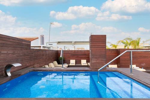 a swimming pool on the roof of a building at Holiday Rentals Tempa Museo in Seville