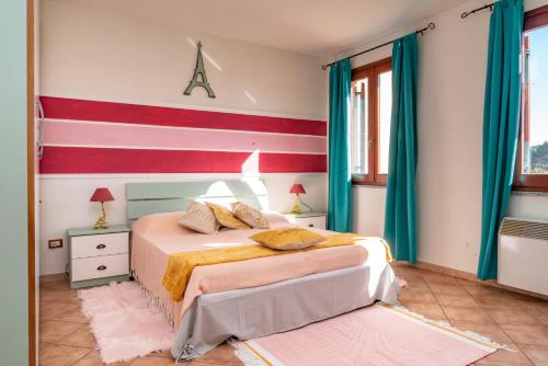 a bedroom with two beds and a red and white striped wall at Nora Guesthouse Rooms and Villas in Pula