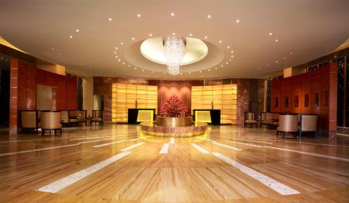 a large lobby with a dance floor and a chandelier at Vivanta Coimbatore in Coimbatore