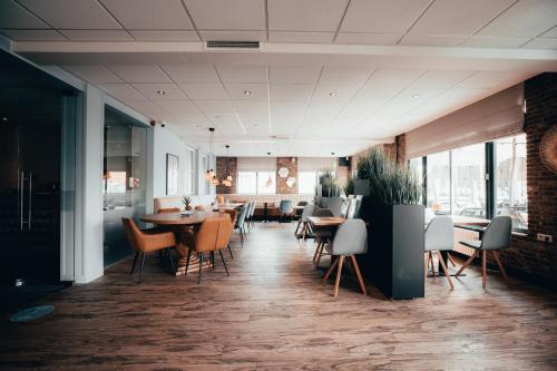 een restaurant met tafels en stoelen in een kamer bij Strandhotel Zoutelande in Zoutelande