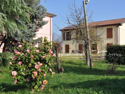 een huis met een bos van rozen in een tuin bij Agriturismo La Prosciutta in Faenza