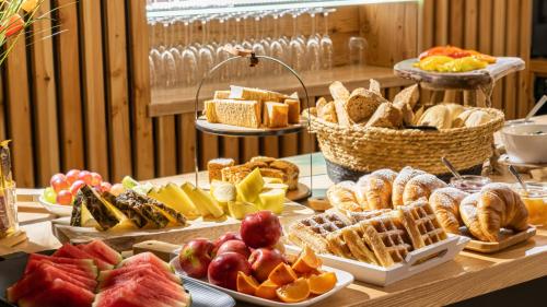 een tafel gevuld met verschillende soorten brood en gebak bij Wrota Chałubińskiego in Zakopane