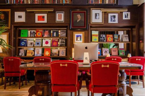 a dining room with a table with a laptop on it at Browns Boutique Hotel in Lisbon