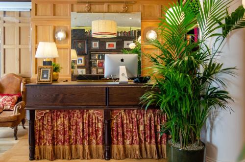 an office with a desk with a computer and a plant at Browns Boutique Hotel in Lisbon