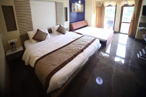 a bedroom with a large bed and a couch at The Byke Heritage Adventure Park & Resort, Matheran in Matheran