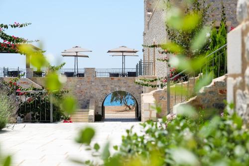 an entrance to a brick building with an archway at Margo Beach Hotel in Gythio