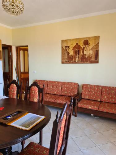 uma sala de jantar com sofás e uma mesa em Djarfogo house em São Filipe