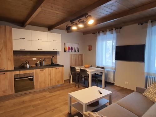 a kitchen and living room with a couch and a table at Moda Apartments 01 in Sestriere