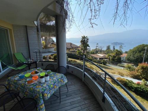 a table on a balcony with a view of the ocean at Emma in Verbania