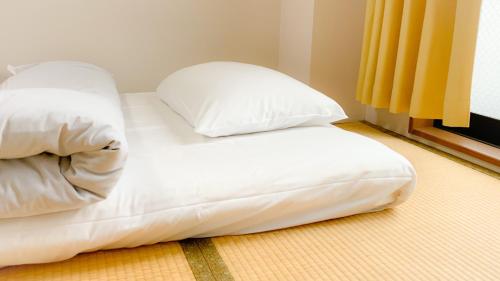 מיטה או מיטות בחדר ב-Guesthouse Kyoto Abiya