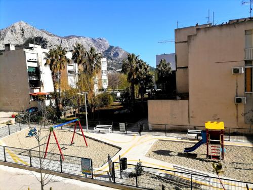 a park with a playground in a city at Apartman Nela in Omiš