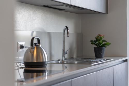 a kitchen with a sink with a tea kettle on it at Casa Raffaello in San Miniato