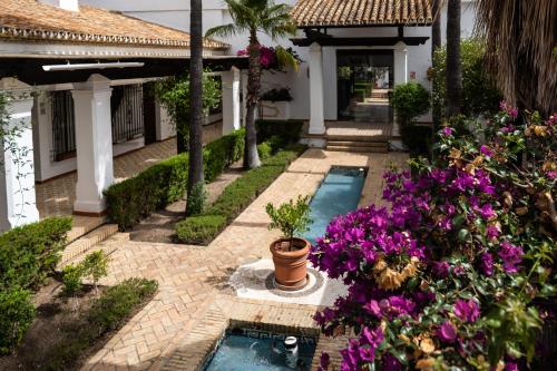 een huis met een zwembad en wat bloemen bij Moon Dreams El Cortijo in Matalascañas