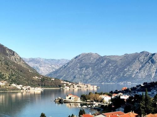 a view of a large body of water with mountains at De Lux Apartments Sirena in Kotor