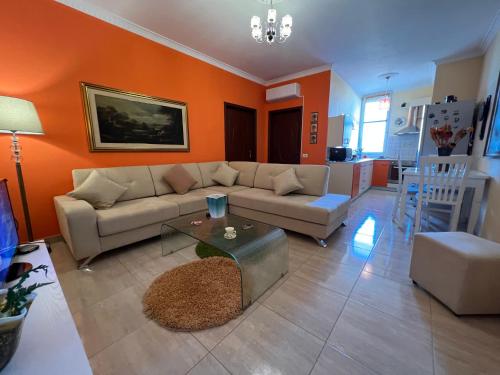 a living room with a couch and a table at City Center Apartment in Shkoder in Shkodër