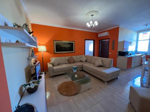 a living room with a couch and a table at City Center Apartment in Shkoder in Shkodër