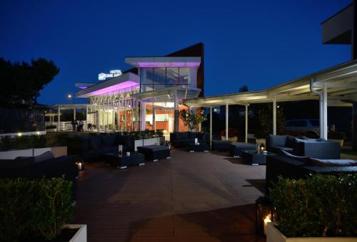 a building with tables and chairs at night at Best Western Hotel Rome Airport in Fiumicino