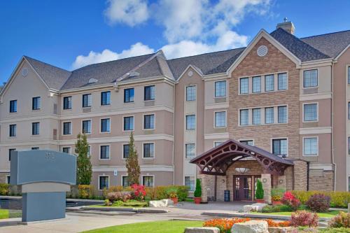 a large building with a sign in front of it at Sonesta ES Suites Toronto Markham in Markham