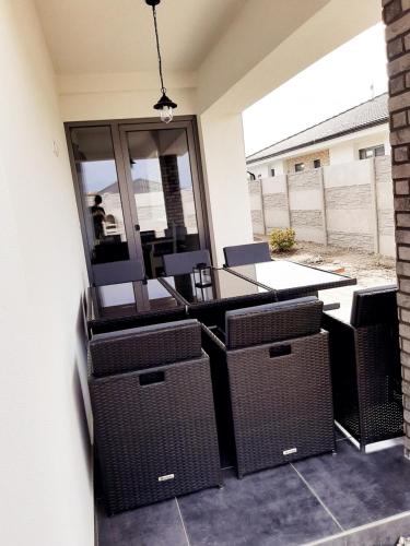 a patio with wicker chairs and a table on a patio at Ubytování Valentovi in Veľký Meder