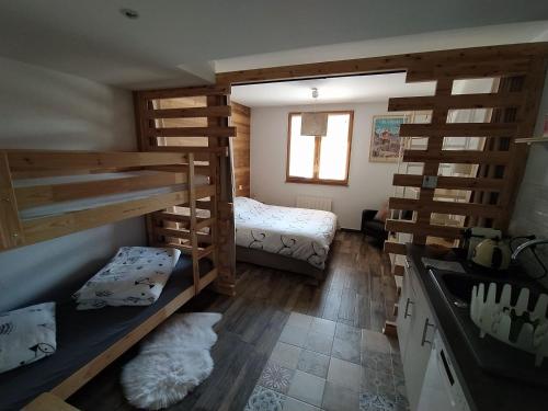 a room with two bunk beds and a bed at Chez Alphonse in Thônes