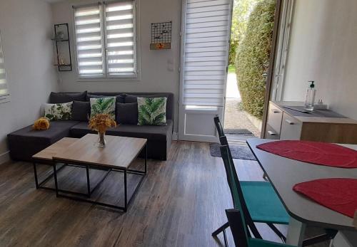 a living room with a couch and a table at Le PATSA de Vouillé in Vouillé