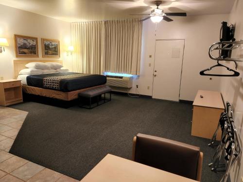 a hotel room with a bed and a camera at Mecca Motel in Colorado Springs