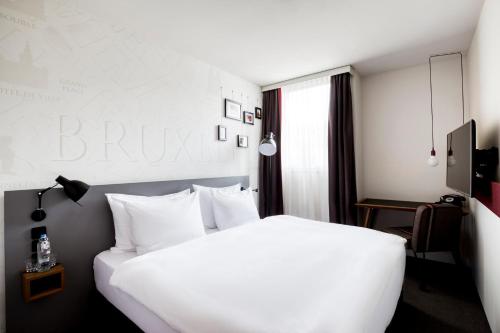 Giường trong phòng chung tại Pentahotel Brussels Airport