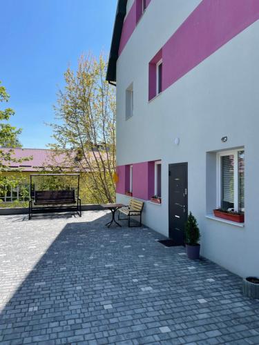 a patio with a bench and a building at Apart-Hotel у центрі Трускавця in Truskavets