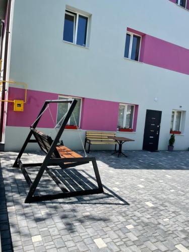 a chair sitting in a courtyard next to a building at Apart-Hotel у центрі Трускавця in Truskavets