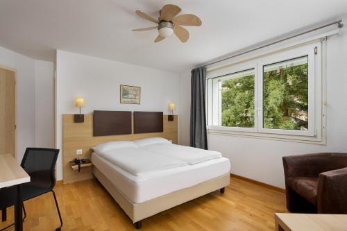 a hotel room with a bed and a window at Bon Port in Montreux