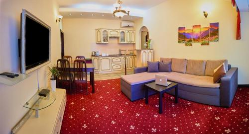 a living room with a couch and a table at Hotel Leo in Lviv